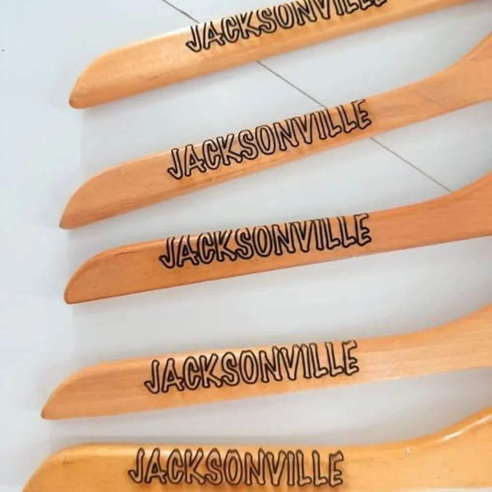 5 custom wood hangers with Jacksonville Jaguars branding.